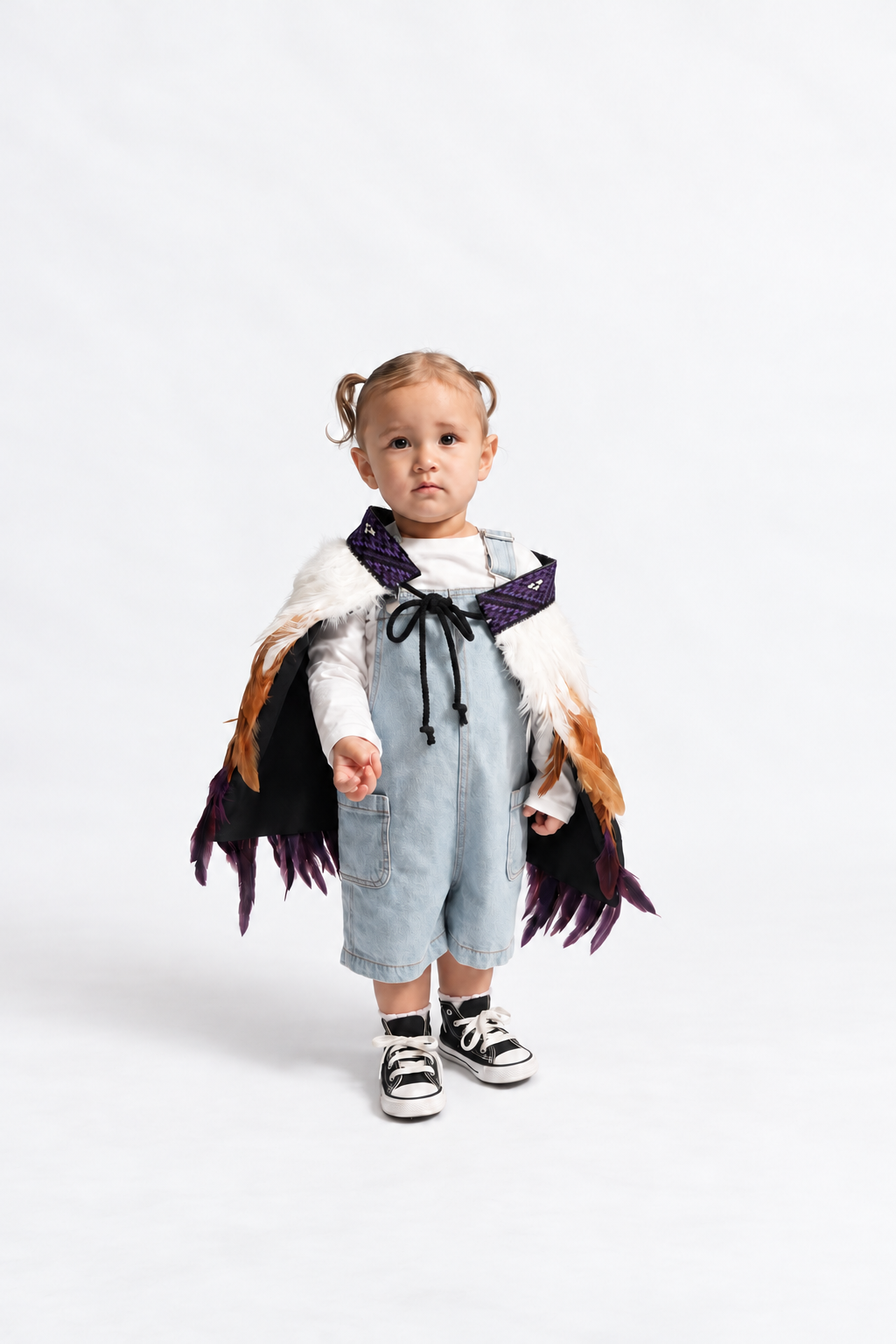 Toddler wearing Wairua Purple korowai, front view