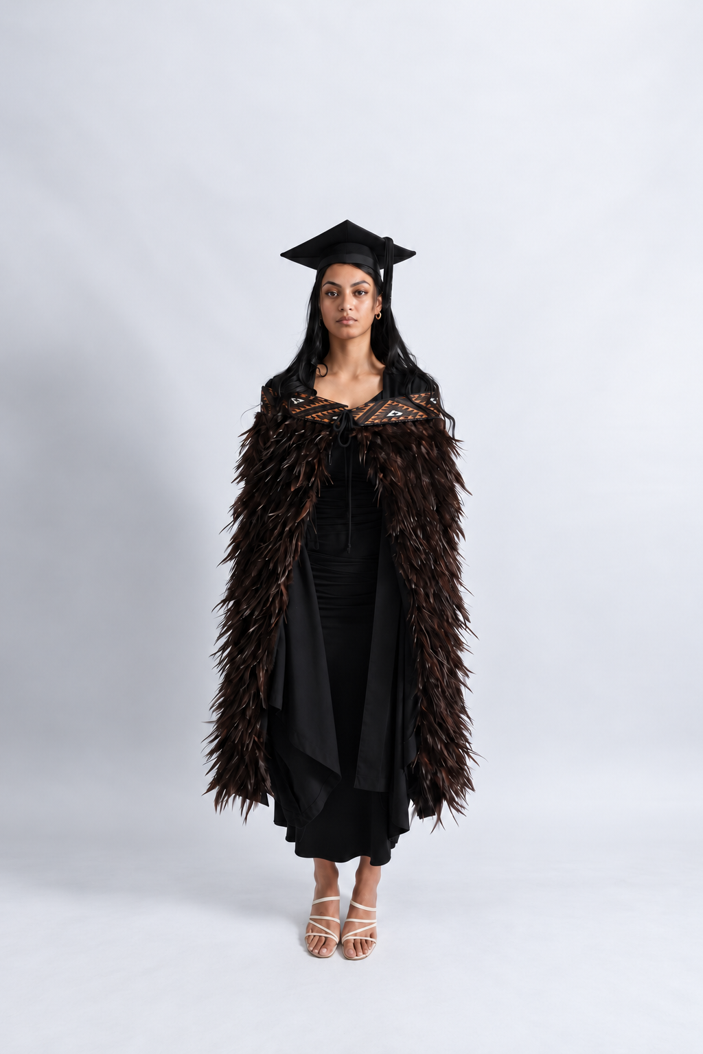 Full-length graduation view of the Kahu Kiwi korowai and its outward-flicking chocolate feathers.