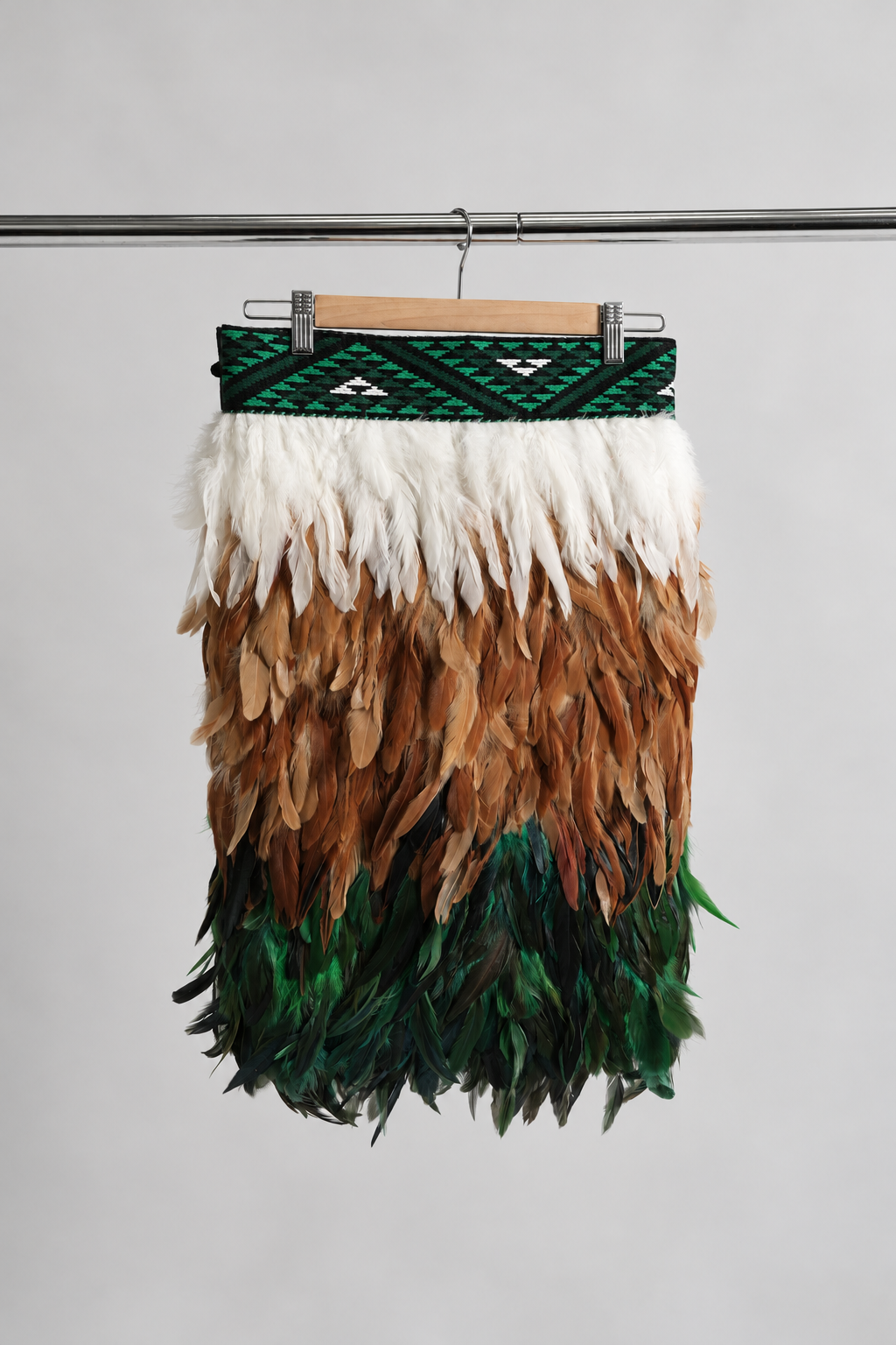 Ngāhere Green contemporary adult korowai in Half length, hanging front view.