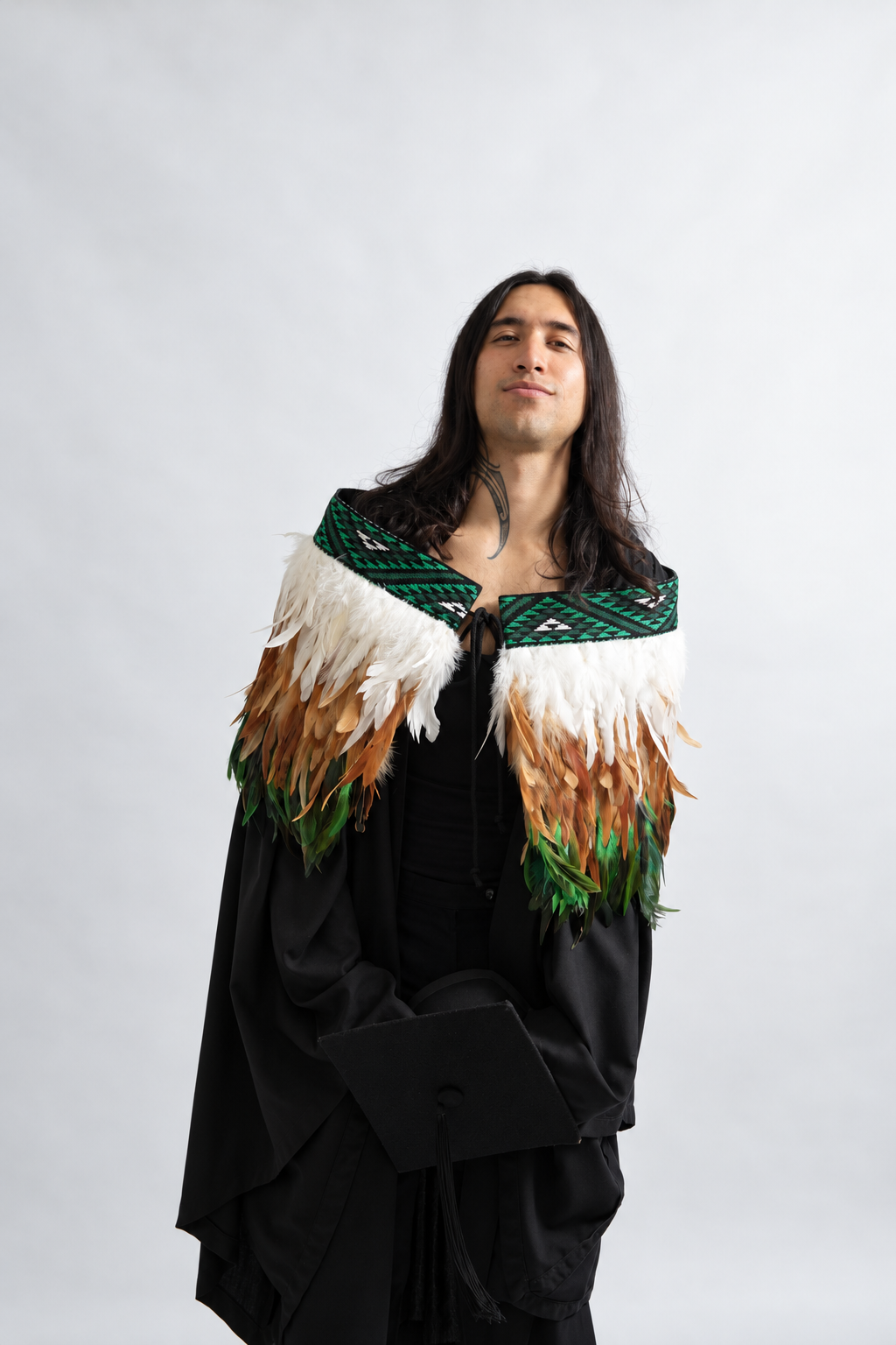 Front view of a model wearing the Ngāhere Green contemporary adult korowai.