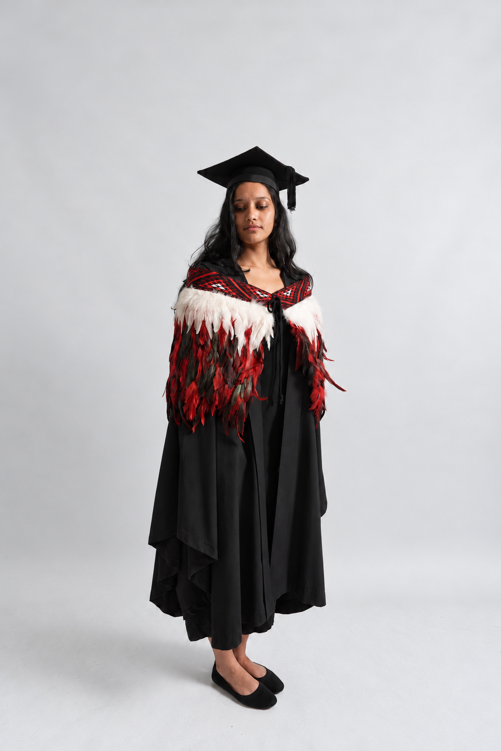 Graduation model wearing Rangatira Red korowai, alternate pose