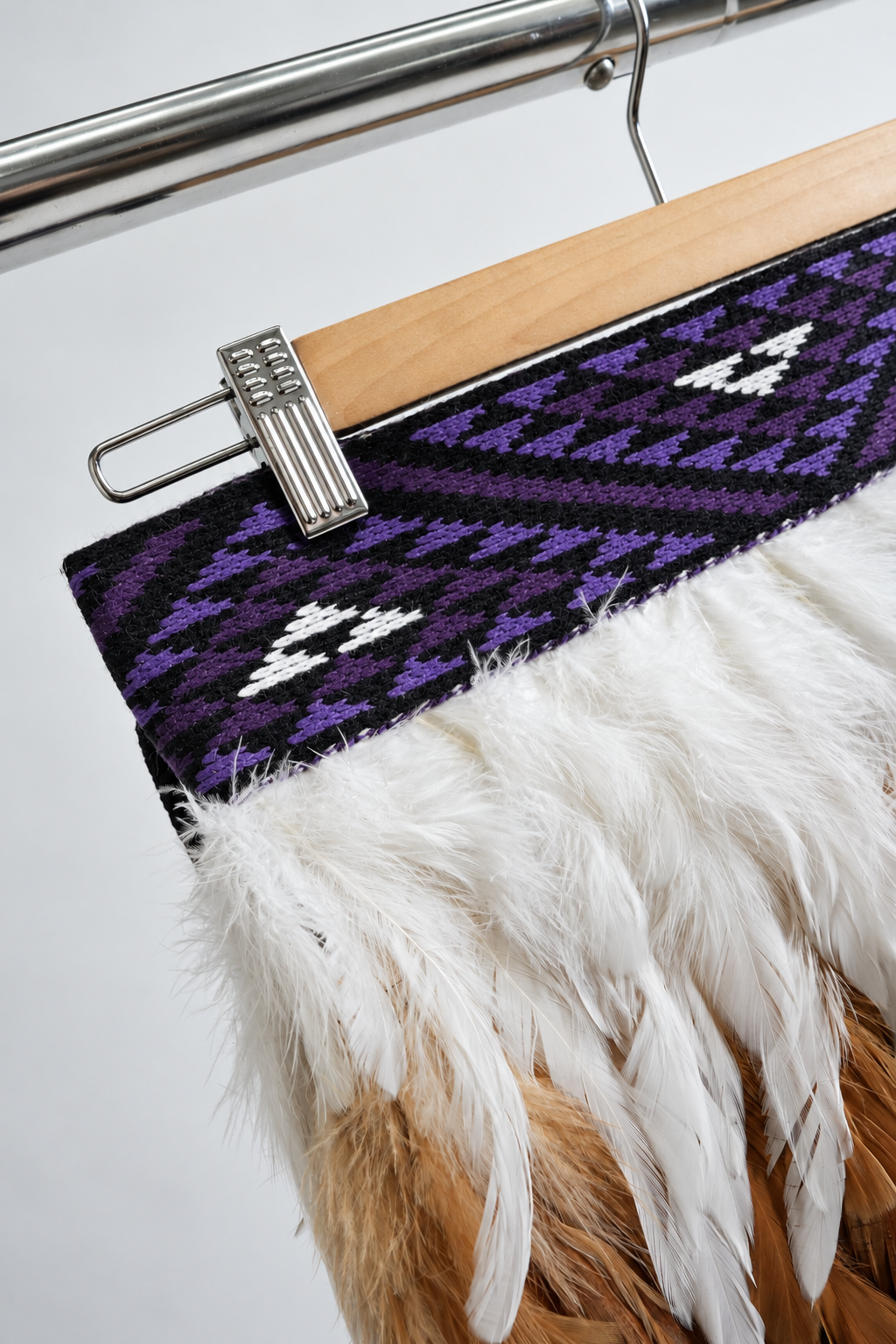Angled close-up of the purple, black and white Wairua tāniko band