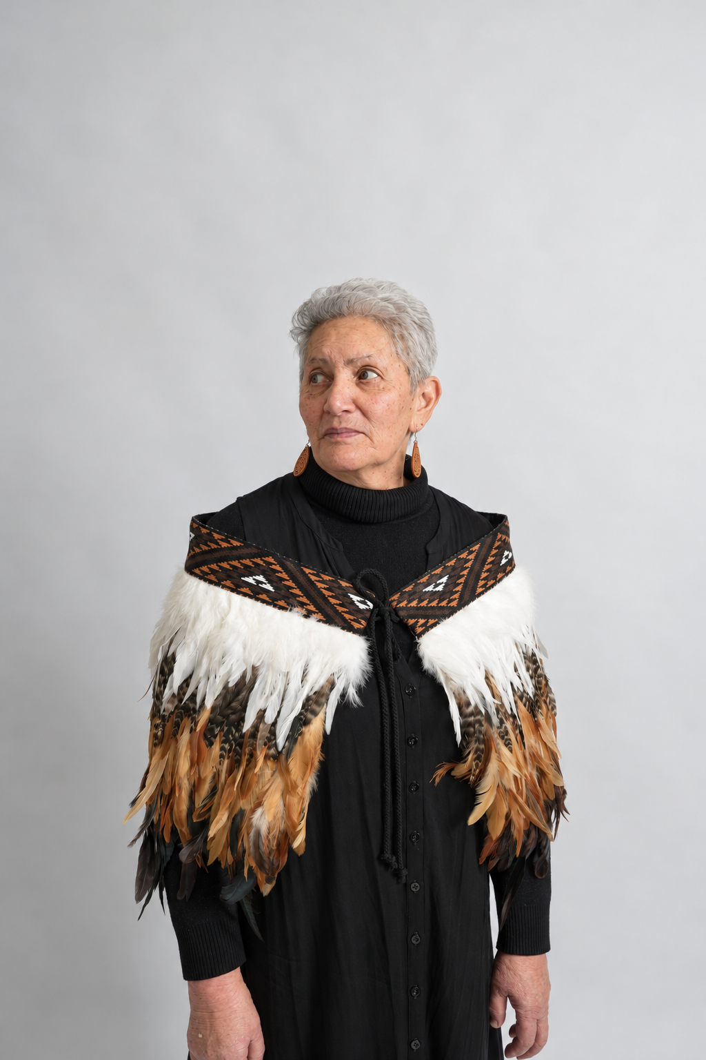 Whenua Brown korowai worn by a model, alternate front view