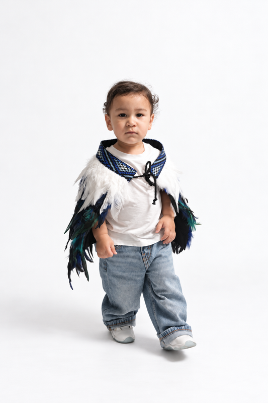 Toddler wearing Moana Blue korowai, walking front view