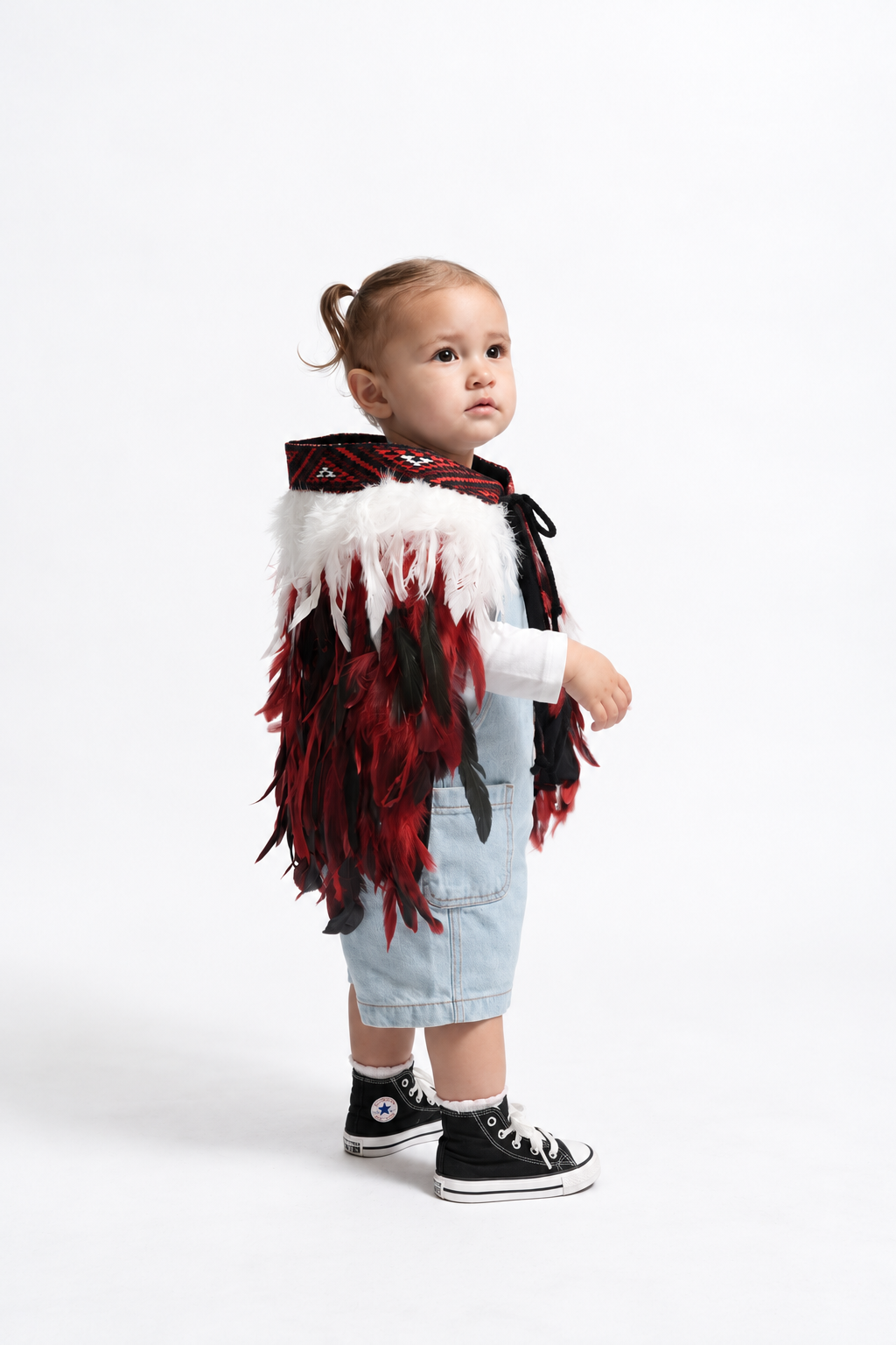 Toddler wearing Rangatira Red korowai, side view