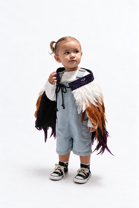 Toddler wearing Wairua Purple korowai, looking up